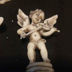 Vintage Creme and Black Cherub Angels with musical Ornaments.